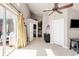 Bright bedroom featuring a ceiling fan, walk out to patio, and a built in shelving unit at 2397 E Iliff Ave, Denver, CO 80210