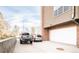 Driveway with two parked cars, and a two-car garage at 2397 E Iliff Ave, Denver, CO 80210