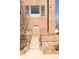 Well-maintained brick townhouse exterior with concrete steps leading to the entrance exudes a classic appeal at 2397 E Iliff Ave, Denver, CO 80210