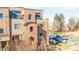 Gorgeous townhome exterior with tasteful brick accents, a balcony, and street parking available at 2397 E Iliff Ave, Denver, CO 80210