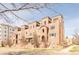 Elegant brick townhouse complex featuring arched entryways and private terraces offers a sophisticated urban living experience at 2397 E Iliff Ave, Denver, CO 80210
