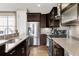 Modern kitchen with stainless steel appliances, quartz countertops, and a stylish backsplash offers a sleek design at 2397 E Iliff Ave, Denver, CO 80210