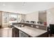 Kitchen island with a sink, seating, and modern finishes at 2397 E Iliff Ave, Denver, CO 80210