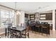 Bright, open-concept kitchen and dining area with hardwood floors and modern stainless steel appliances at 2397 E Iliff Ave, Denver, CO 80210