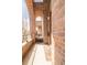 Inviting porch with brick archway offers a private outdoor space with a view, enhancing the townhouse's charm at 2397 E Iliff Ave, Denver, CO 80210