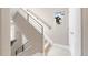Staircase with carpeted treads and skier art at 2397 E Iliff Ave, Denver, CO 80210