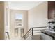 Unique stairway with railing, window view, and beverage center, perfect for entertaining at 2397 E Iliff Ave, Denver, CO 80210