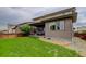 Well-maintained backyard featuring a lush lawn and covered patio, perfect for outdoor relaxation at 10906 Touchstone Loop, Parker, CO 80134