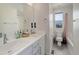 Well-lit bathroom featuring dual sinks, a shower-tub combo, and a large mirror at 10906 Touchstone Loop, Parker, CO 80134