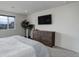 Bright bedroom featuring a large dresser, wall-mounted TV, and ample natural light from a nearby window at 10906 Touchstone Loop, Parker, CO 80134