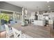 Bright dining room with pendant lighting, wood table and view of the kitchen and outdoor covered patio at 10906 Touchstone Loop, Parker, CO 80134