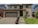 Inviting two-story home with a two-car garage, manicured lawn, and charming curb appeal at 10906 Touchstone Loop, Parker, CO 80134