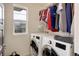 Convenient laundry room with a side-by-side washer and dryer and ample storage shelves at 10906 Touchstone Loop, Parker, CO 80134