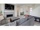 Contemporary living room showcasing a fireplace, large sofa, and modern design elements at 10906 Touchstone Loop, Parker, CO 80134