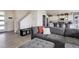 Open-concept living room with a cozy sofa, and stairs to the second floor at 10906 Touchstone Loop, Parker, CO 80134