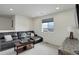 Comfortable living room with a dark leather sofa, wood TV stand, and a large window at 10906 Touchstone Loop, Parker, CO 80134
