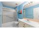 Blue bathroom featuring shower with glass doors, vanity and large mirror at 9491 Southern Hills Cir, Lone Tree, CO 80124
