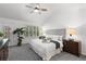 Cozy bedroom with plush carpeting, natural light, and stylish furnishings at 9491 Southern Hills Cir, Lone Tree, CO 80124