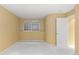 A bedroom featuring yellow walls, a window and a white door at 9491 Southern Hills Cir, Lone Tree, CO 80124