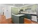 View of kitchen with green cabinets, stainless appliances and tile backsplash at 9491 Southern Hills Cir, Lone Tree, CO 80124