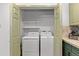 View of in-unit laundry closet with shelving and two machines at 9491 Southern Hills Cir, Lone Tree, CO 80124