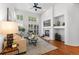 Bright living room boasts a fireplace, hardwood floors, and lots of natural light at 9491 Southern Hills Cir, Lone Tree, CO 80124