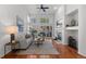 Bright living room boasts a fireplace, hardwood floors, and lots of natural light at 9491 Southern Hills Cir, Lone Tree, CO 80124