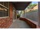Picturesque covered patio with brick accents and views of the landscaped backyard at 9491 Southern Hills Cir, Lone Tree, CO 80124
