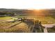 Stunning aerial view of a beautiful ranch home with rolling hills at sunset at 6330 Old Orchard Ln, Sedalia, CO 80135