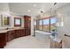A spacious bathroom has a free-standing tub, large windows, and a granite shower at 6330 Old Orchard Ln, Sedalia, CO 80135