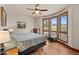 Inviting bedroom featuring hardwood floors, a ceiling fan, and a window with beautiful views of the outdoors at 6330 Old Orchard Ln, Sedalia, CO 80135
