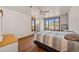 Bright bedroom with hardwood floors, a ceiling fan, and a window with views of the scenic outdoors at 6330 Old Orchard Ln, Sedalia, CO 80135