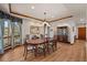 Elegant dining room featuring a large window, hardwood floors, and a beautiful chandelier at 6330 Old Orchard Ln, Sedalia, CO 80135