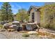 Charming home exterior with a decorative rock water feature in the front yard at 6330 Old Orchard Ln, Sedalia, CO 80135