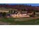 A beautifully landscaped home with a large back patio area and a stone retaining wall at 6330 Old Orchard Ln, Sedalia, CO 80135