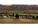 Expansive ranch style home showcasing beautiful landscape and illuminated front porch at 6330 Old Orchard Ln, Sedalia, CO 80135