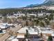 Aerial view of property featuring wooded landscape and mountain views at 16 Prairie St, Palmer Lake, CO 80133