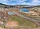 Beautiful aerial view showcasing pickleball and baseball courts, a lake and lush green spaces at 16 Prairie St, Palmer Lake, CO 80133