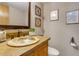 Unique bathroom with a designer sink, warm lighting, and decorative wall art at 16 Prairie St, Palmer Lake, CO 80133