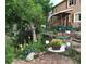 Landscaped front yard with flowers, trees, and seating area at 16 Prairie St, Palmer Lake, CO 80133