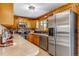 The kitchen features wooden cabinets, stainless steel appliances, and a countertop with a sink and window at 16 Prairie St, Palmer Lake, CO 80133