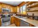 Bright kitchen showcasing wooden cabinets, stainless steel appliances, and a sink beneath a window at 16 Prairie St, Palmer Lake, CO 80133