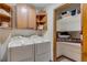 Efficient laundry room with washer, dryer, and ample shelving for storage at 16 Prairie St, Palmer Lake, CO 80133