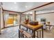 Open-concept area with bar seating and access to an outdoor space with a hot tub, perfect for entertaining at 16 Prairie St, Palmer Lake, CO 80133