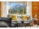 Cozy living space with a view of the mountains, stylish decor, and comfortable seating at 16 Prairie St, Palmer Lake, CO 80133