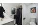 Modern bathroom featuring a sleek sink, toilet, and shower with stylish black hardware at 21111 E 43Rd Ave, Denver, CO 80249