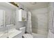 Cozy bathroom featuring a toilet, sink, mirror, bath tub, and tiled shower with floral shower curtain at 21111 E 43Rd Ave, Denver, CO 80249