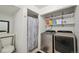 A bathroom and laundry room, featuring a shower, toilet, and modern washer and dryer units at 21111 E 43Rd Ave, Denver, CO 80249