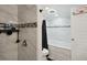 Bright bathroom featuring a bathtub, shower with elegant gray tile, and a fun basketball hoop at 21111 E 43Rd Ave, Denver, CO 80249