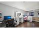 A multifunctional space featuring an office area, vanity, and cozy sleeping nook with a crib at 21111 E 43Rd Ave, Denver, CO 80249